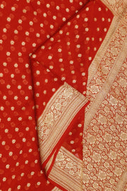 Banarasi silk georgette saree  in red with small motifs all over the body.