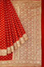 Banarasi silk georgette saree  in red with small motifs all over the body.