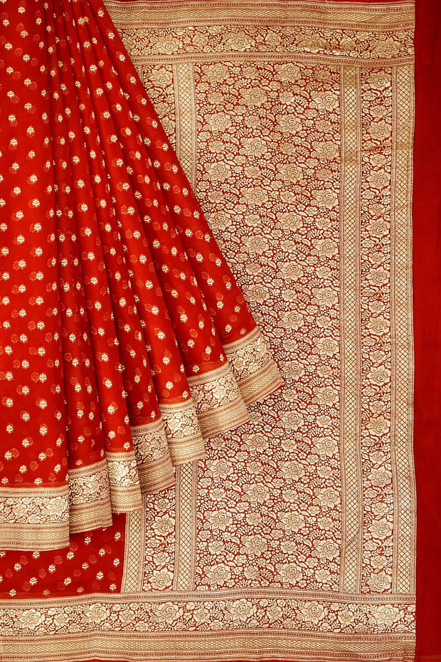 Banarasi silk georgette saree  in red with small motifs all over the body.