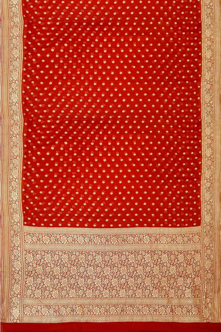 Banarasi silk georgette saree  in red with small motifs all over the body.