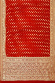 Banarasi silk georgette saree  in red with small motifs all over the body.