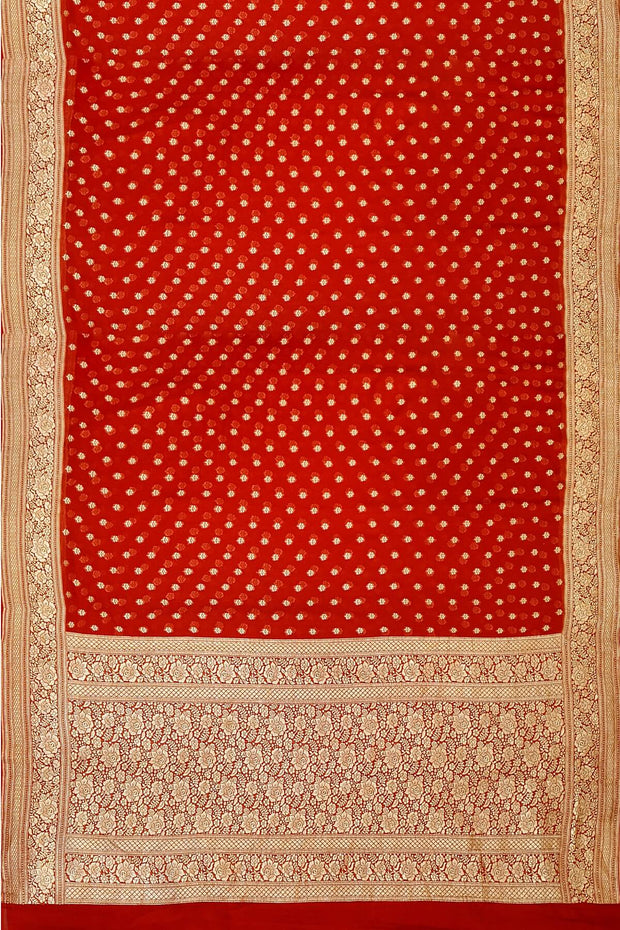 Banarasi silk georgette saree  in red with small motifs all over the body.