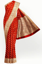 Banarasi silk georgette saree  in red with small motifs all over the body.