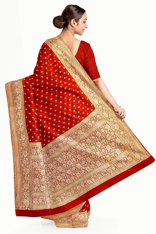 Banarasi silk georgette saree  in red with small motifs all over the body.