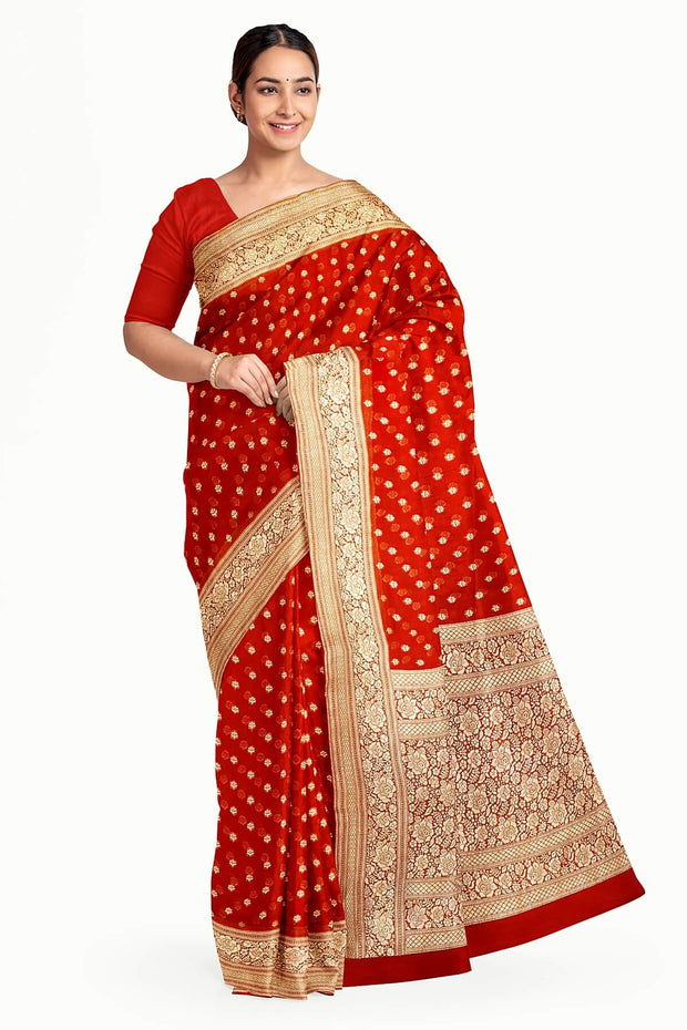 Banarasi silk georgette saree  in red with small motifs all over the body.