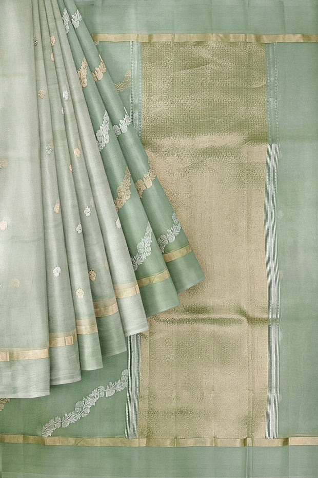 Banarasi kora (organza) silk saree in sage green in half & half style.