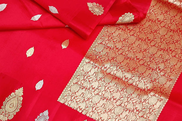 Banarasi kora (organza) silk saree in red with   floral motifs in gold & silver.