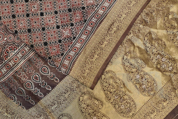 Dola silk saree in chickoo colour  with hand block Ajrakh print  with  paisley motifs in rich tissue pallu