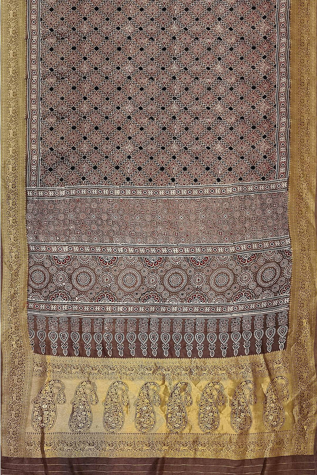 Dola silk saree in chickoo colour  with hand block Ajrakh print  with  paisley motifs in rich tissue pallu