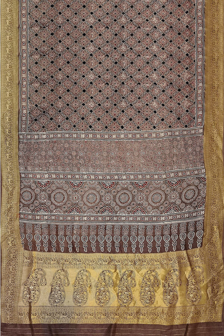 Dola silk saree in chickoo colour  with hand block Ajrakh print  with  paisley motifs in rich tissue pallu