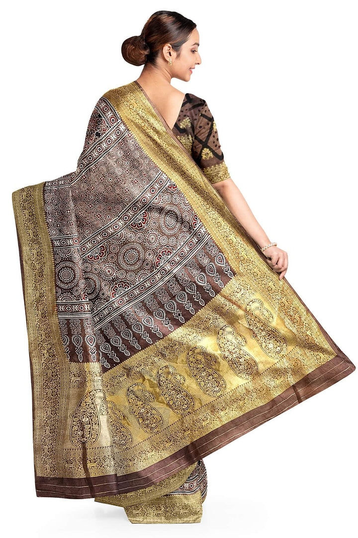 Dola silk saree in chickoo colour  with hand block Ajrakh print  with  paisley motifs in rich tissue pallu