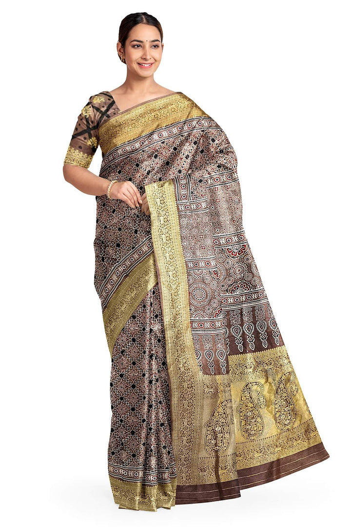 Dola silk saree in chickoo colour  with hand block Ajrakh print  with  paisley motifs in rich tissue pallu