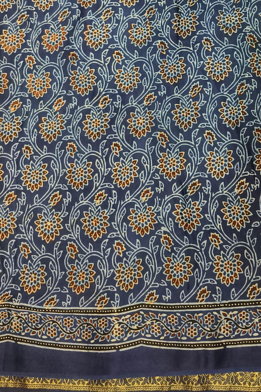 Dola silk saree in blue & black with floral motifs in  hand block Ajrakh print .