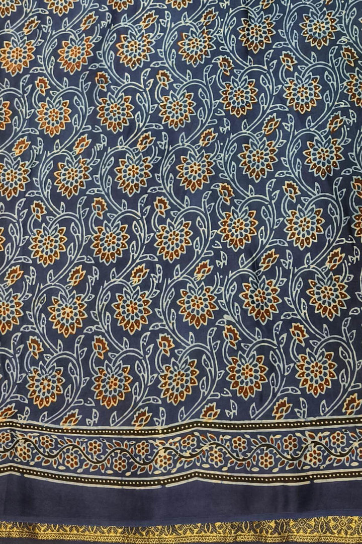 Dola silk saree in blue & black with floral motifs in  hand block Ajrakh print .