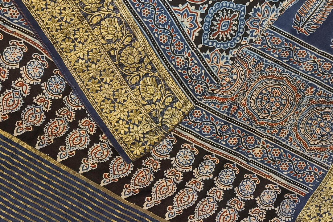 Dola silk saree in blue & black with floral motifs in  hand block Ajrakh print .