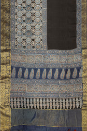 Dola silk saree in blue & black with floral motifs in  hand block Ajrakh print .