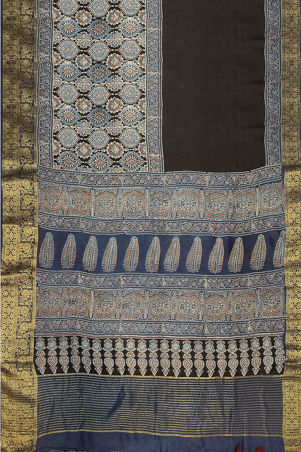 Dola silk saree in blue & black with floral motifs in  hand block Ajrakh print .