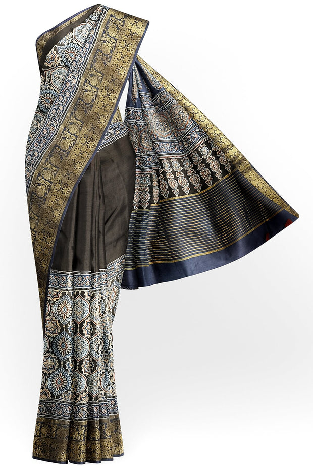 Dola silk saree in blue & black with floral motifs in  hand block Ajrakh print .