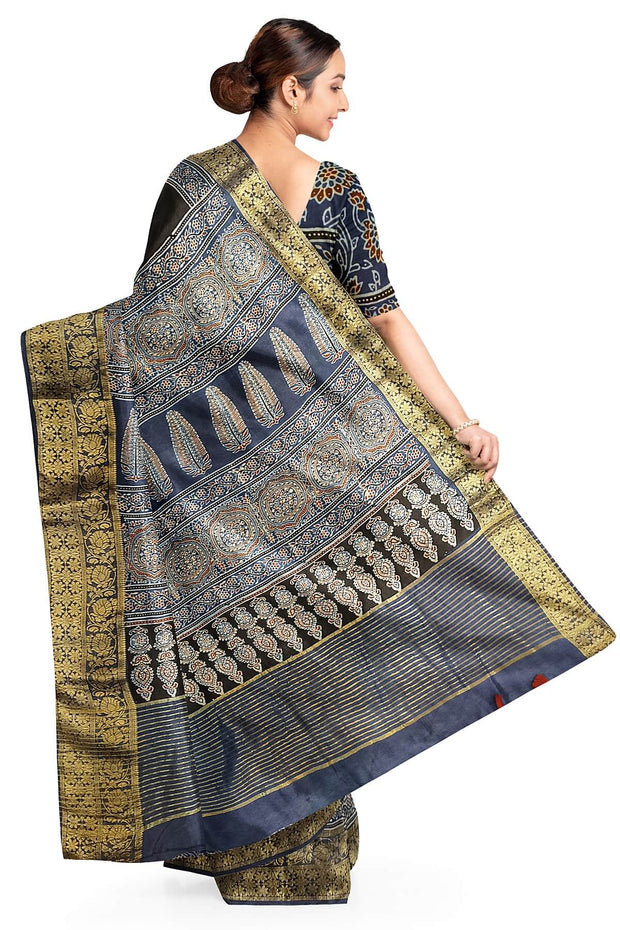Dola silk saree in blue & black with floral motifs in  hand block Ajrakh print .
