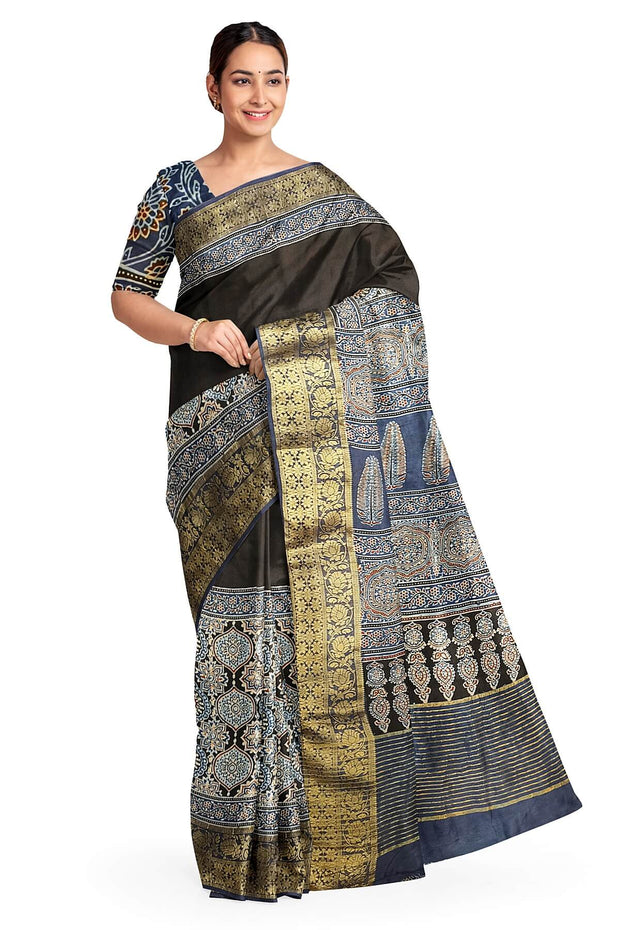 Dola silk saree in blue & black with floral motifs in  hand block Ajrakh print .