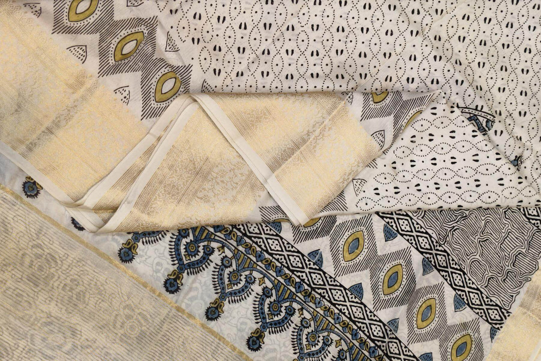 Dola silk saree in white with   hand block Ajrakh print .