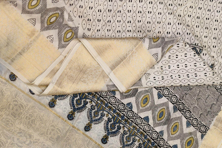 Dola silk saree in white with   hand block Ajrakh print .
