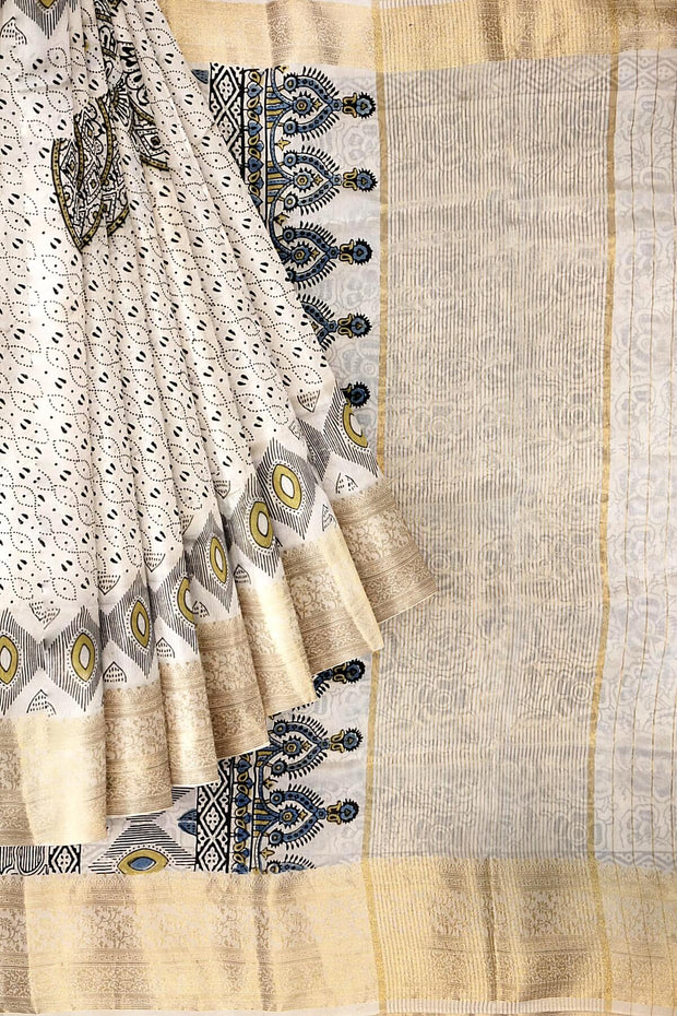 Dola silk saree in white with   hand block Ajrakh print .