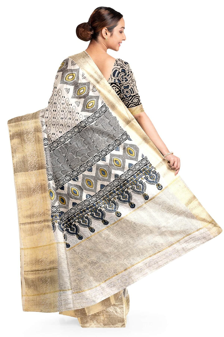 Dola silk saree in white with   hand block Ajrakh print .