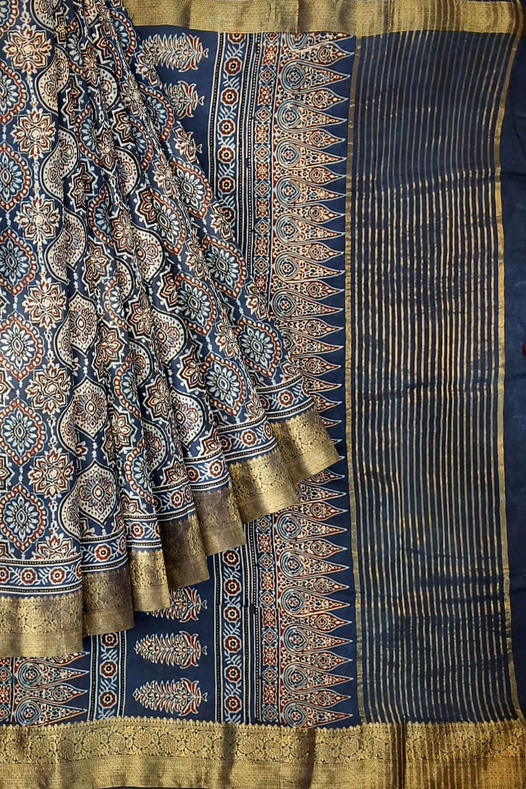 Dola silk saree in blue  with floral motifs in  hand block Ajrakh print .