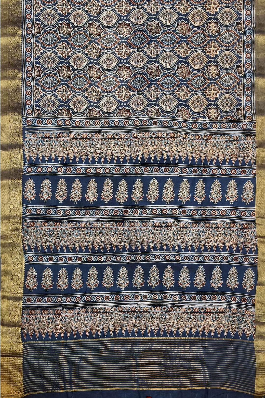 Dola silk saree in blue  with floral motifs in  hand block Ajrakh print .