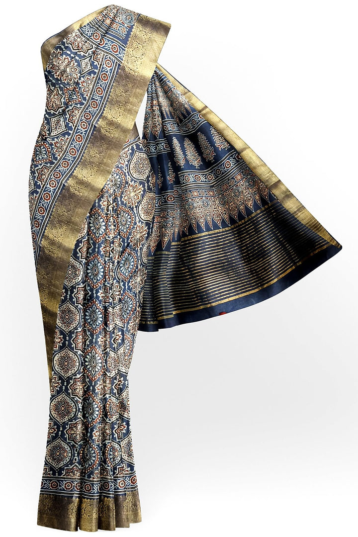 Dola silk saree in blue  with floral motifs in  hand block Ajrakh print .