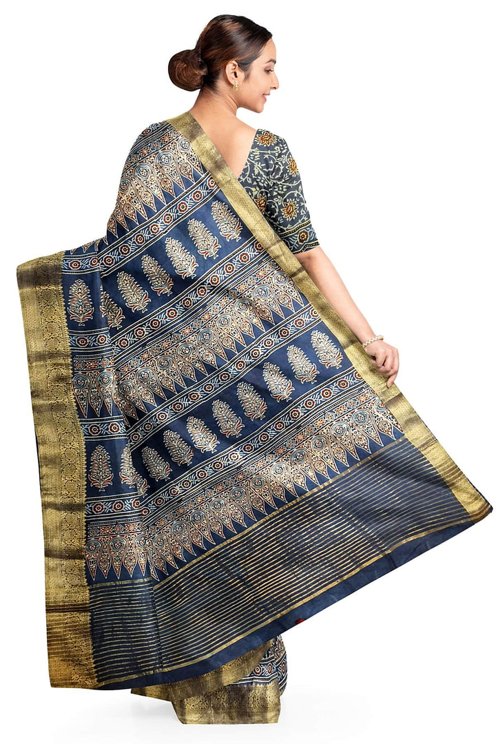 Dola silk saree in blue  with floral motifs in  hand block Ajrakh print .