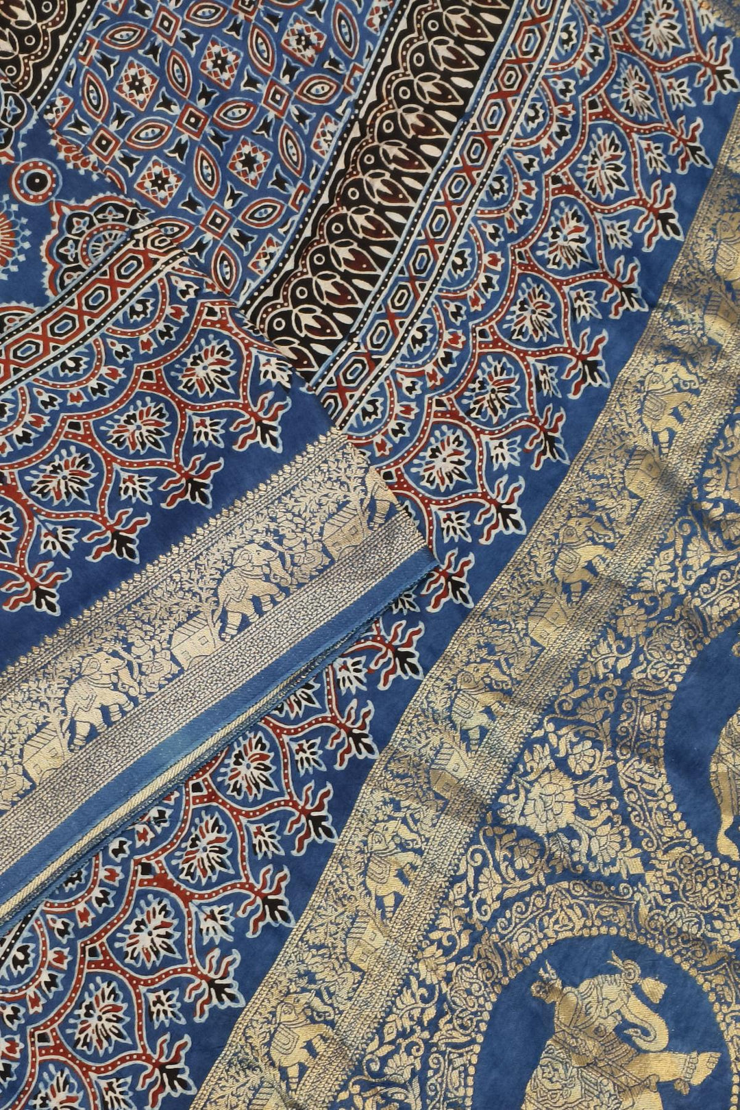 Dola silk saree in blue & red with floral motifs and a skirt border in hand block Ajrakh print