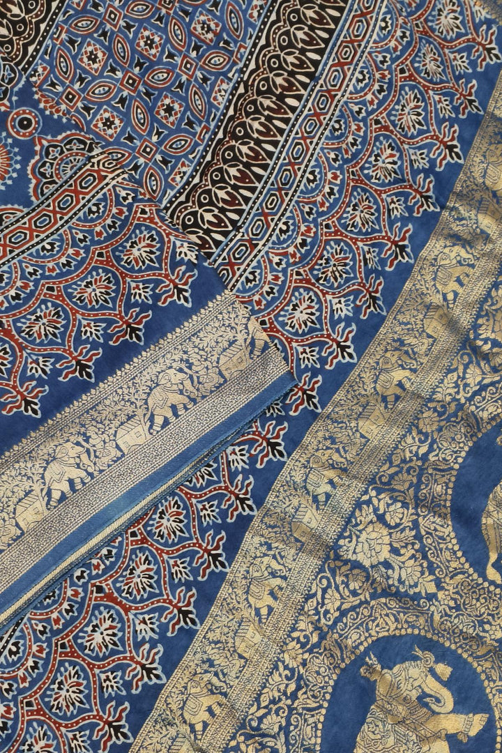 Dola silk saree in blue & red with floral motifs and a skirt border in hand block Ajrakh print
