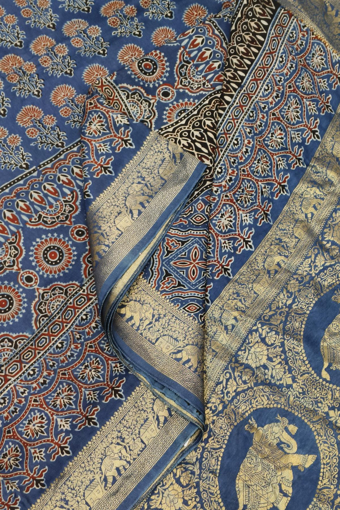 Dola silk saree in blue & red with floral motifs and a skirt border in hand block Ajrakh print