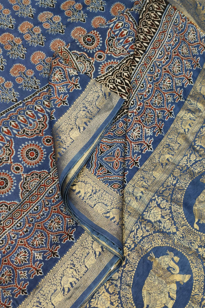 Dola silk saree in blue & red with floral motifs and a skirt border in hand block Ajrakh print