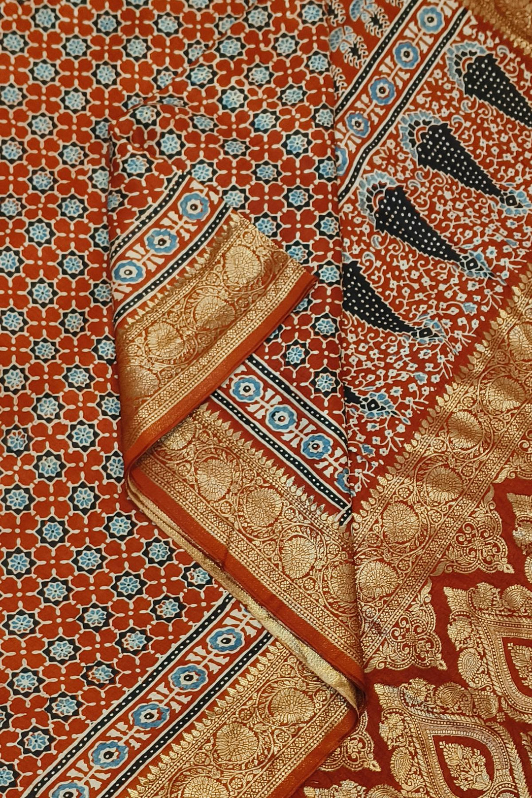 Dola silk saree in red with small motifs  and a contrast pallu in hand block Ajrakh print