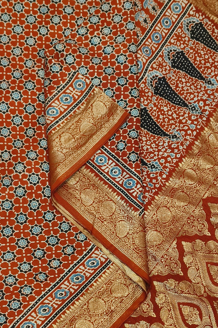 Dola silk saree in red with small motifs  and a contrast pallu in hand block Ajrakh print