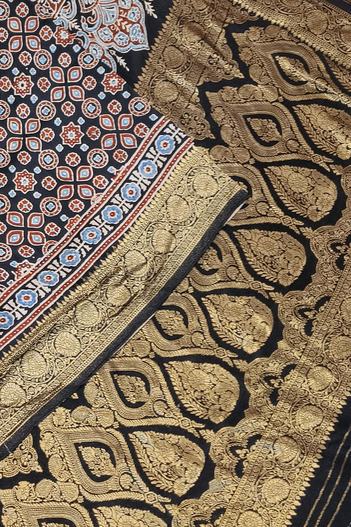Dola silk saree in black with small motifs  and a contrast pallu in hand block Ajrakh print