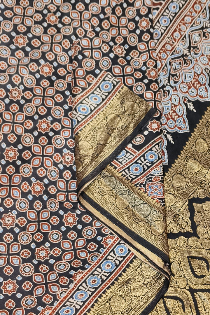 Dola silk saree in black with small motifs  and a contrast pallu in hand block Ajrakh print