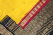 Handwoven Gadwal pure silk saree in yellow  with small motifs and contrast pallu in black .