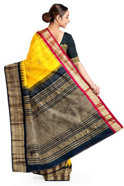 Handwoven Gadwal pure silk saree in yellow  with small motifs and contrast pallu in black .