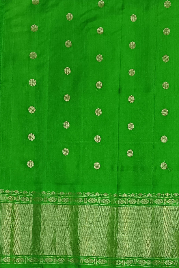 Handwoven Gadwal pure silk saree in violet  with round motifs and  a contrast pallu in green .