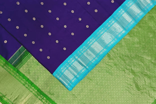 Handwoven Gadwal pure silk saree in violet  with round motifs and  a contrast pallu in green .
