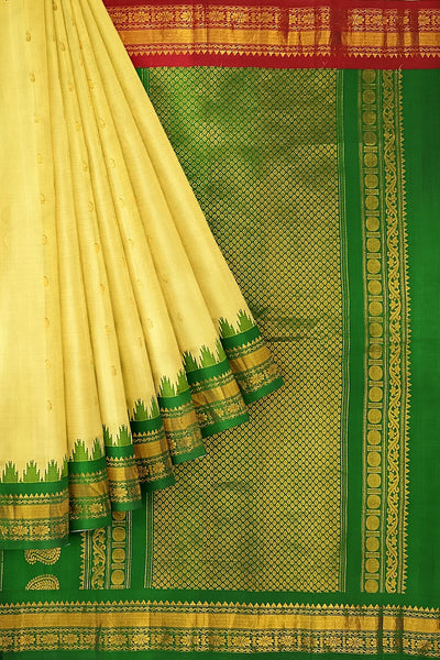 Handwoven Gadwal pure silk saree in cream  with paisley  motifs and  a contrast pallu in green .