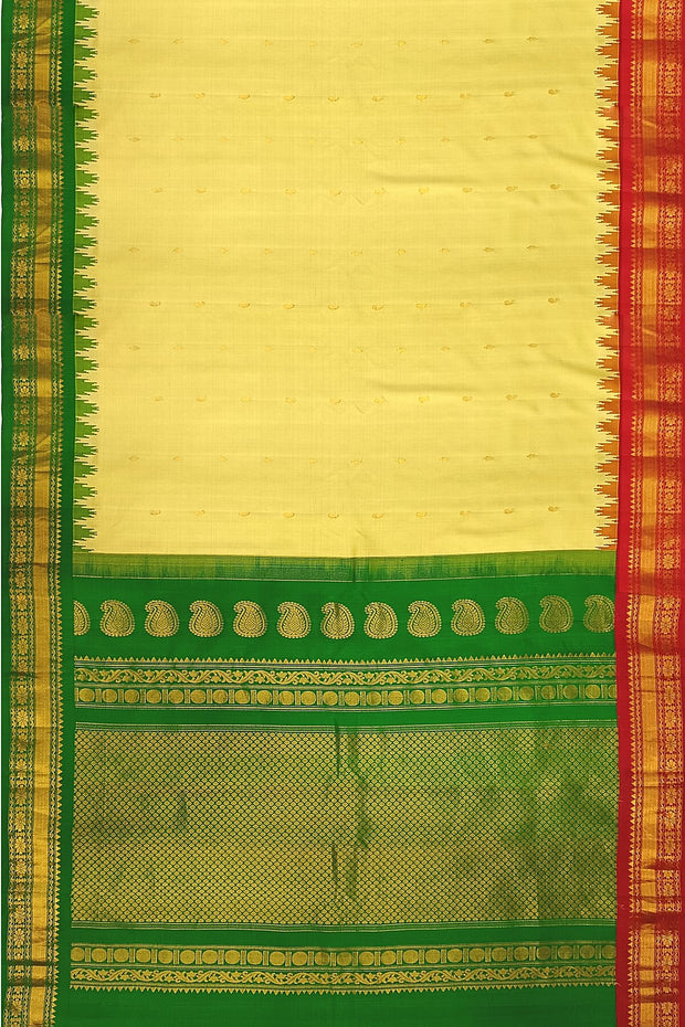 Handwoven Gadwal pure silk saree in cream  with paisley  motifs and  a contrast pallu in green .