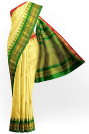 Handwoven Gadwal pure silk saree in cream  with paisley  motifs and  a contrast pallu in green .