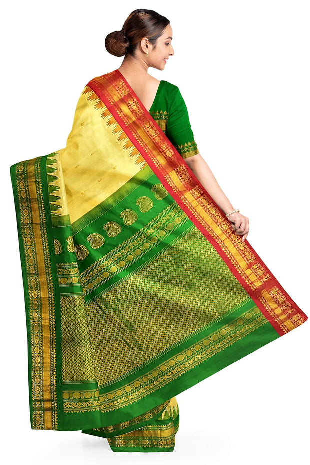 Handwoven Gadwal pure silk saree in cream  with paisley  motifs and  a contrast pallu in green .