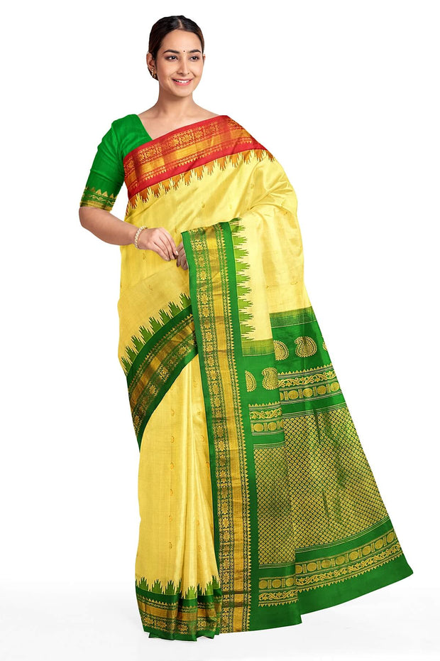 Handwoven Gadwal pure silk saree in cream  with paisley  motifs and  a contrast pallu in green .