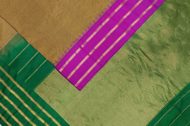 Handwoven Gadwal pure silk saree in mustard & black  in fine checks   and  a contrast pallu in green .